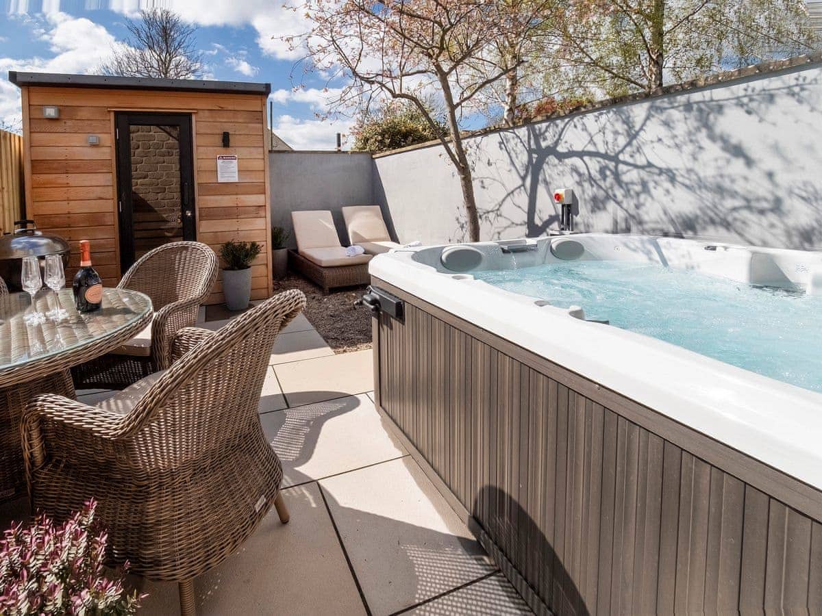 Back garden view, hot tub and dining area